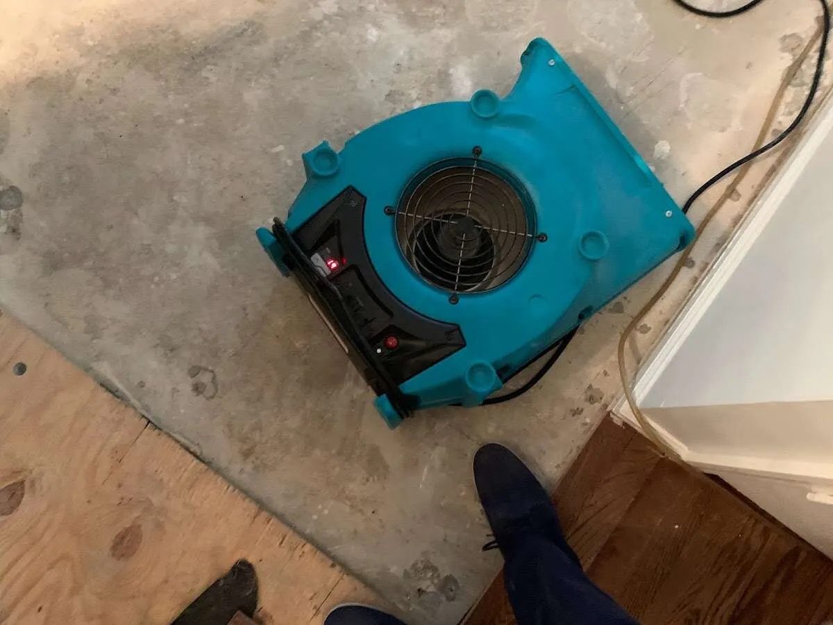 Air mover drying subfloor during Commercial Water Damage Restoration in Fort Pierce